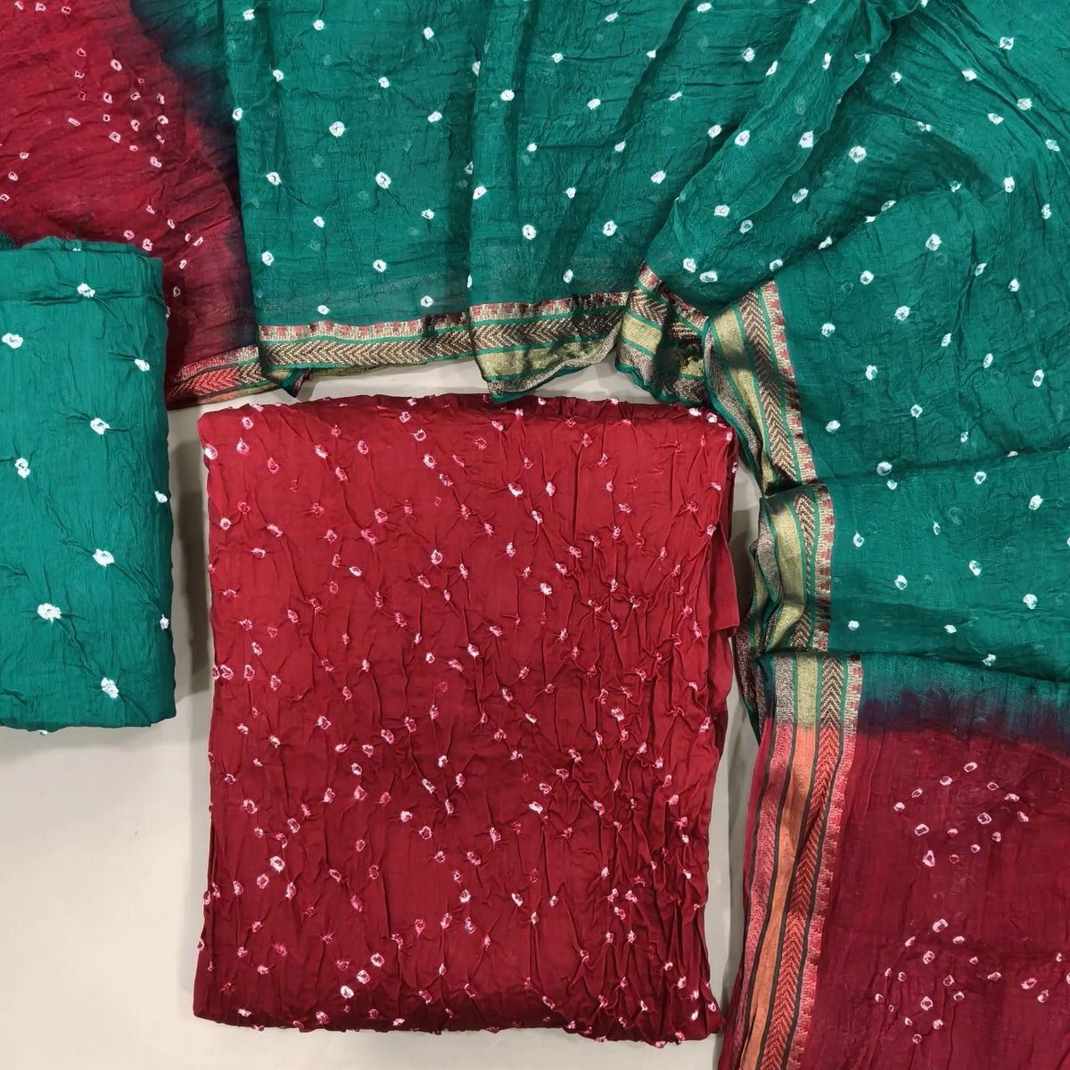 Red bandhini tie and dye pure cotton unstitched salwar material,(lining needed)turquoise green tie and dye cotton bottom,dual shaded tie and dye mul cotton dupatta with resham borders. OC261307