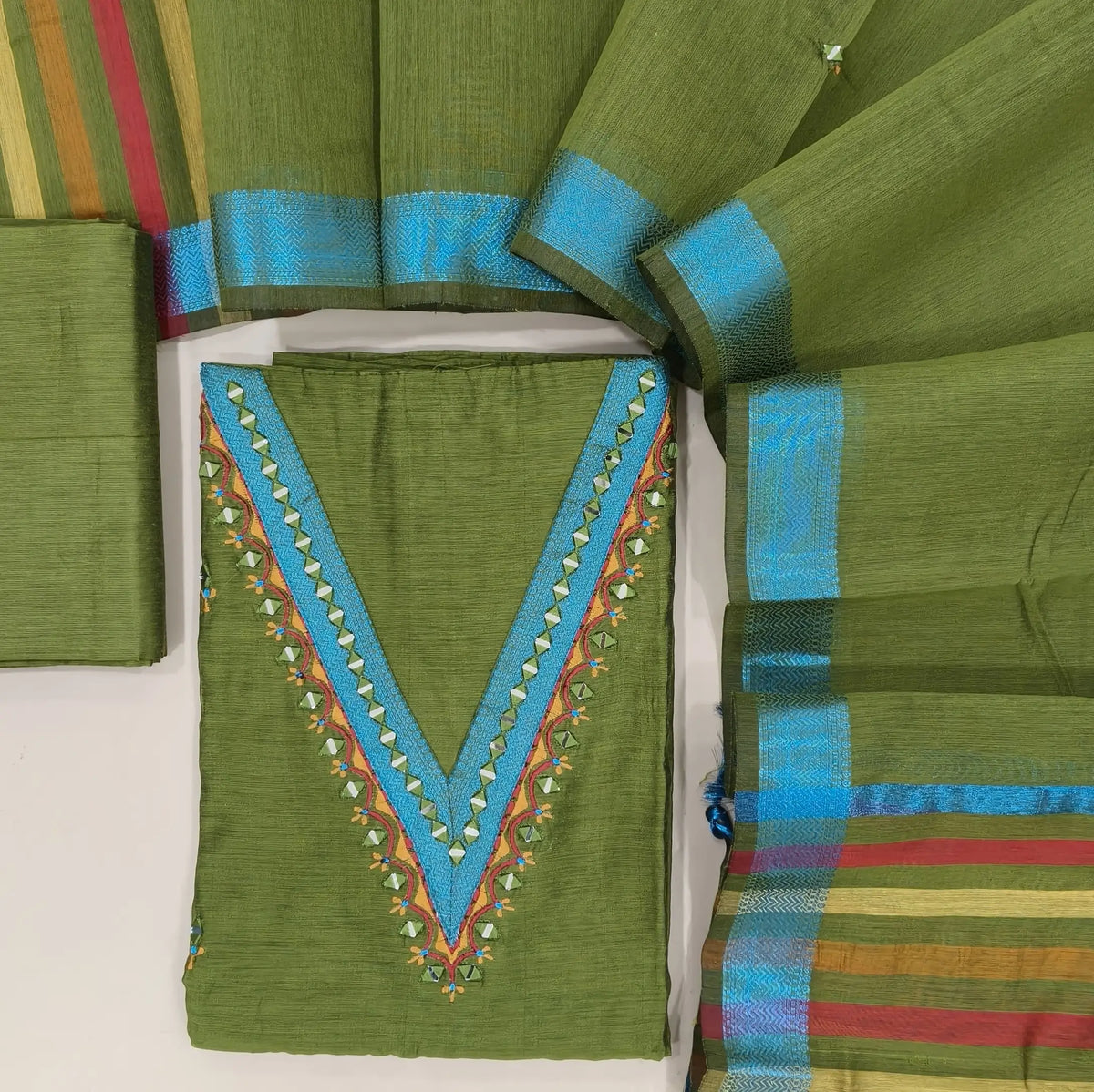 Designer leafy green silk cotton unstitched salwar material, thread borders and real mirror(lining needed)silk cotton bottom,embroidery and real mirror silk cotton dupatta with blue zari borders & pallu. OC261315
