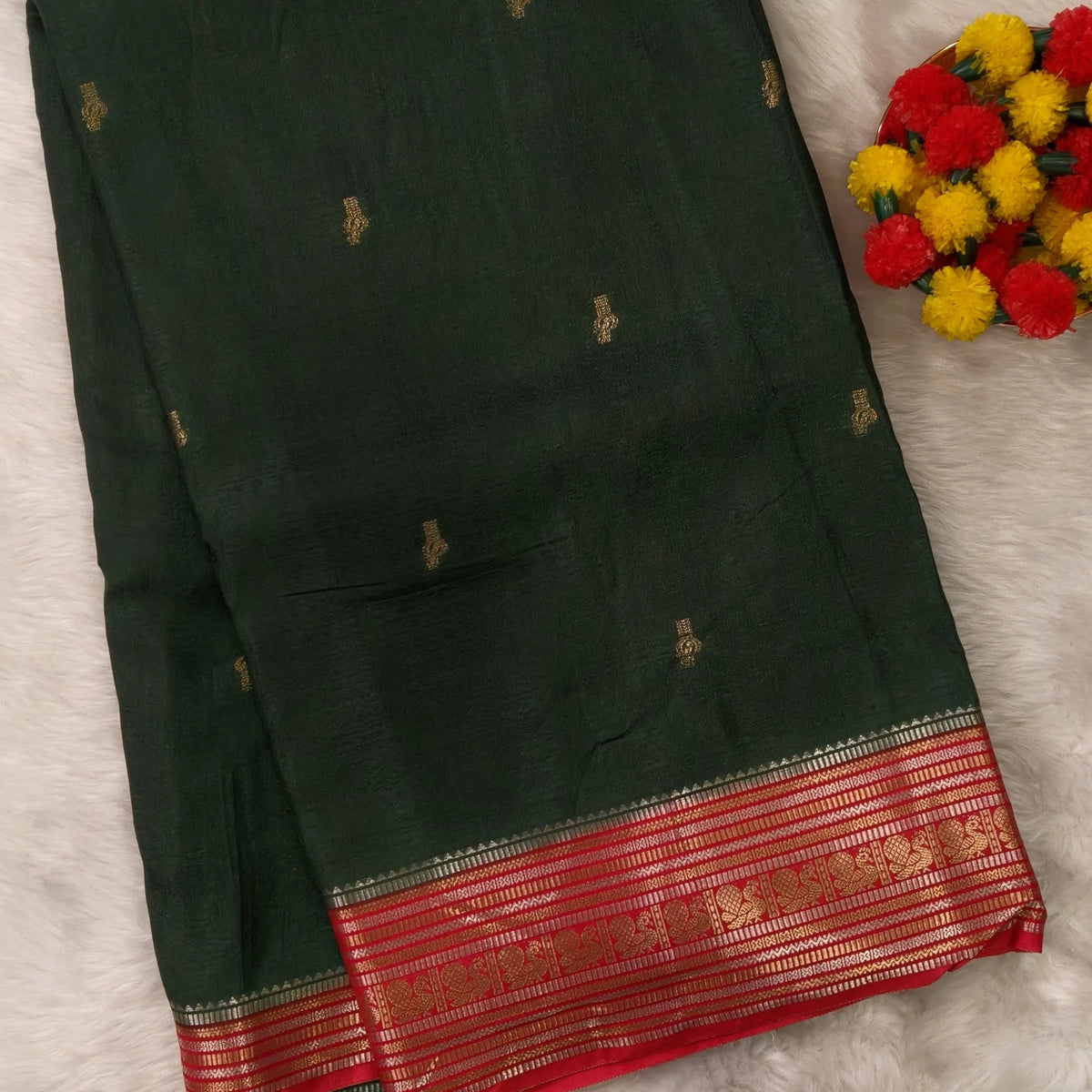 Dark green jakard viscous silk saree with zari woven buttas all over, contrast double side gold and silver zari woven border (Silky, Thin)Contrast pallu with striped, crepe silk blouse with zari buttas. NS367