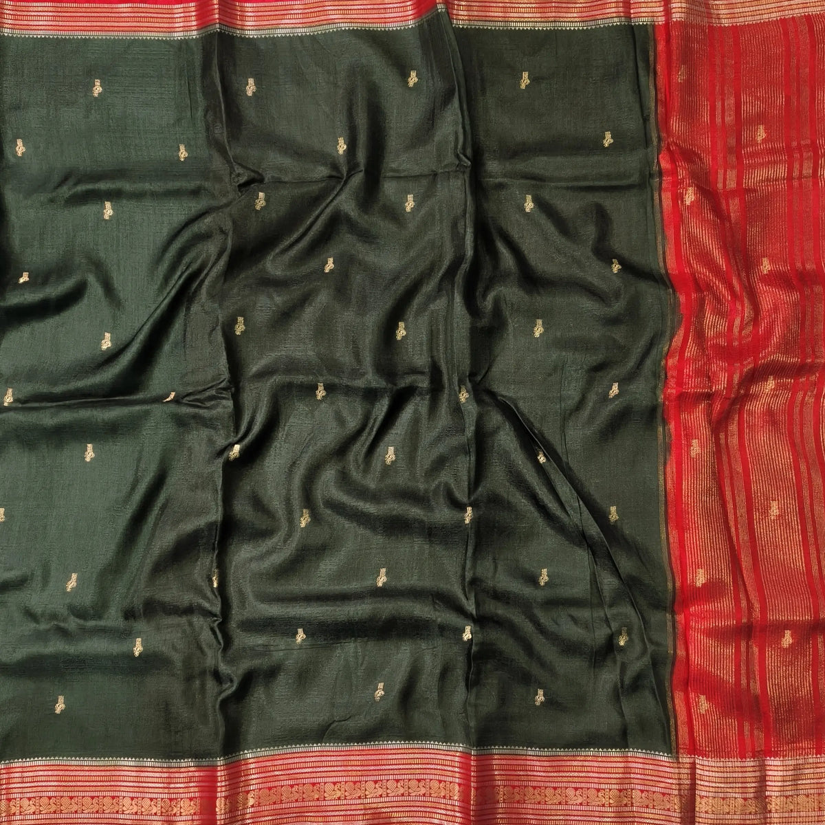 Dark green jakard viscous silk saree with zari woven buttas all over, contrast double side gold and silver zari woven border (Silky, Thin)Contrast pallu with striped, crepe silk blouse with zari buttas. NS367