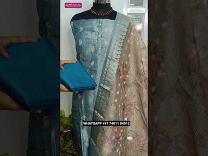 Blue with silver tint tissue silk cotton unstitched salwar material, silver zari buttas all over(thin, lining needed)dark teal blue silk cotton bottom, floral printed crinkled tissue silk cotton dupatta with zari borders. CODE AG251406