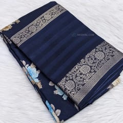 CODE WS945 : Navy blue fancy dola silk saree with beautiful floral prints all over, big gap borders on one side, ikat printed pallu,plain running blouse with borders.