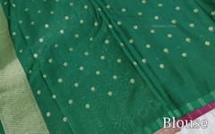 CODE WS1195 : Beetroot purple banarasi viscous georgette saree with antique gold zari woven buttas all over,zari woven pallu and rich zari woven pallu(lightweight)contrast dark green blouse with zari woven buttas with borders.